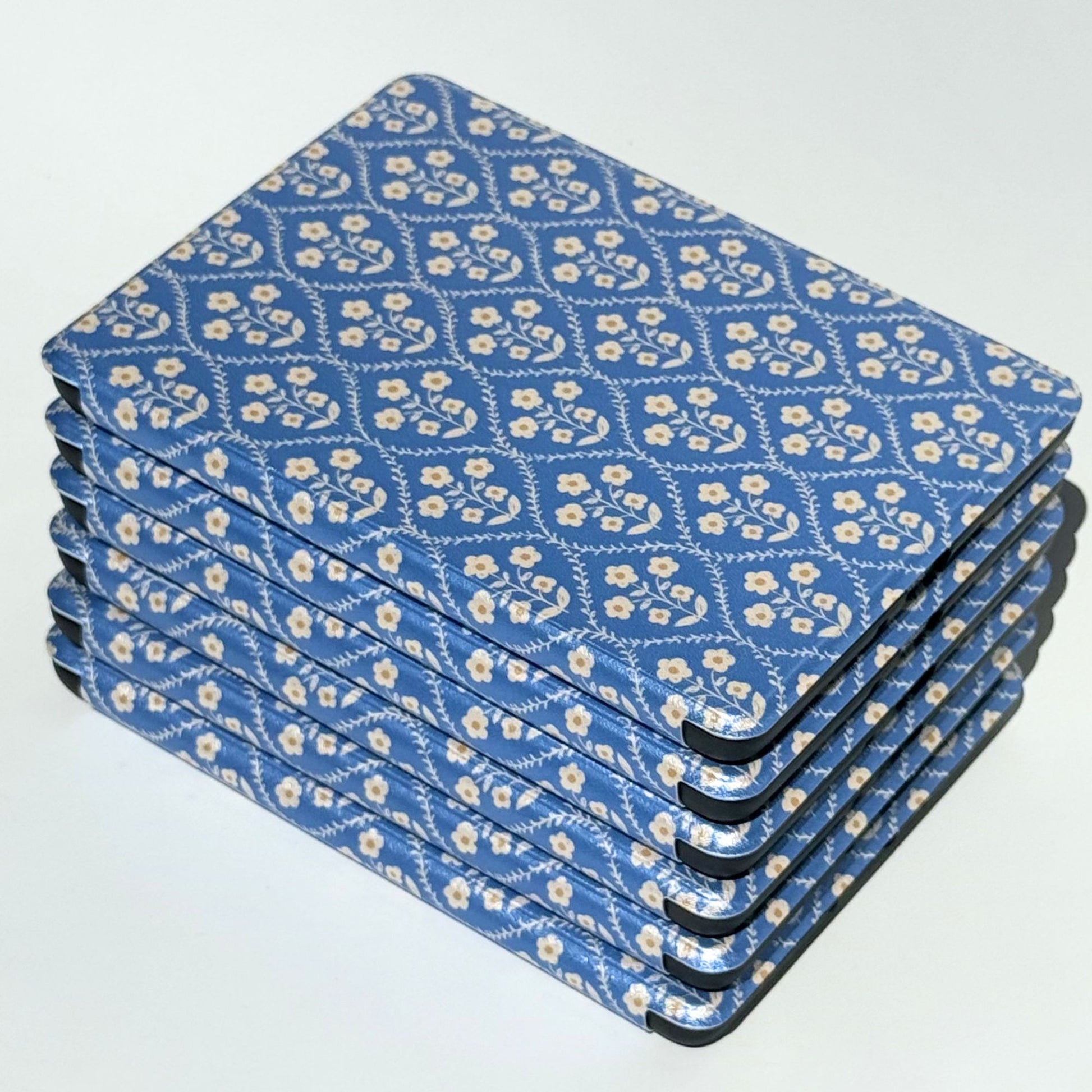 Bluebell blue floral Kindle cases stacked at angles, showing the soft vintage print on every cover