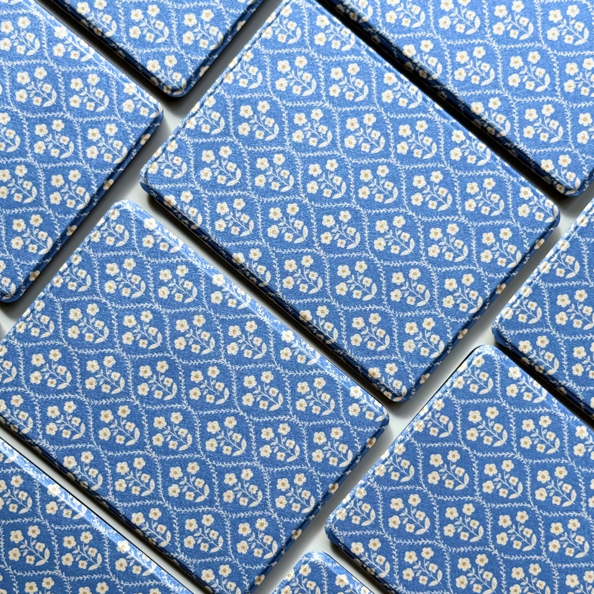Detail of the Bluebell print, vintage cream flowers on blue for a floral cottagecore Kindle case