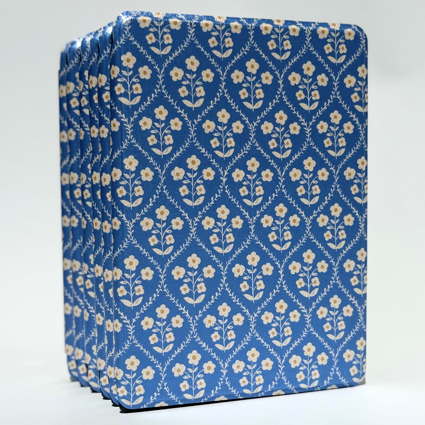 Front view of the Bluebell Kindle case standing upright, showing its blue and cream floral cover