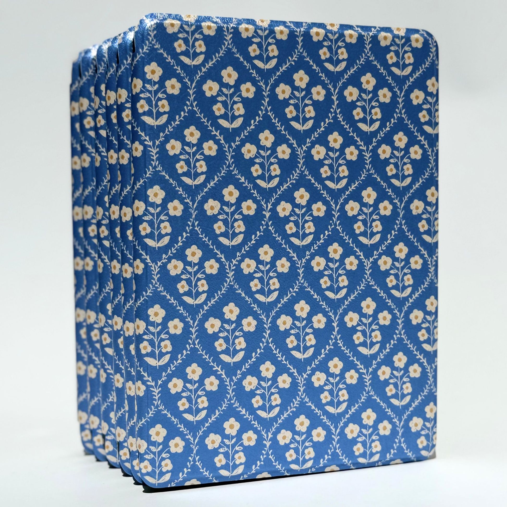 Front view of the Bluebell Kindle case standing upright, showing its blue and cream floral cover