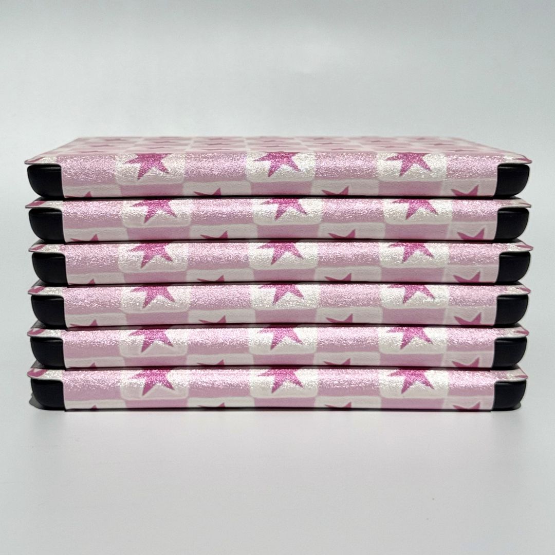 Aerial view of stacked Blush Cosmos Kindle cases — pink star print Kindle case Australia