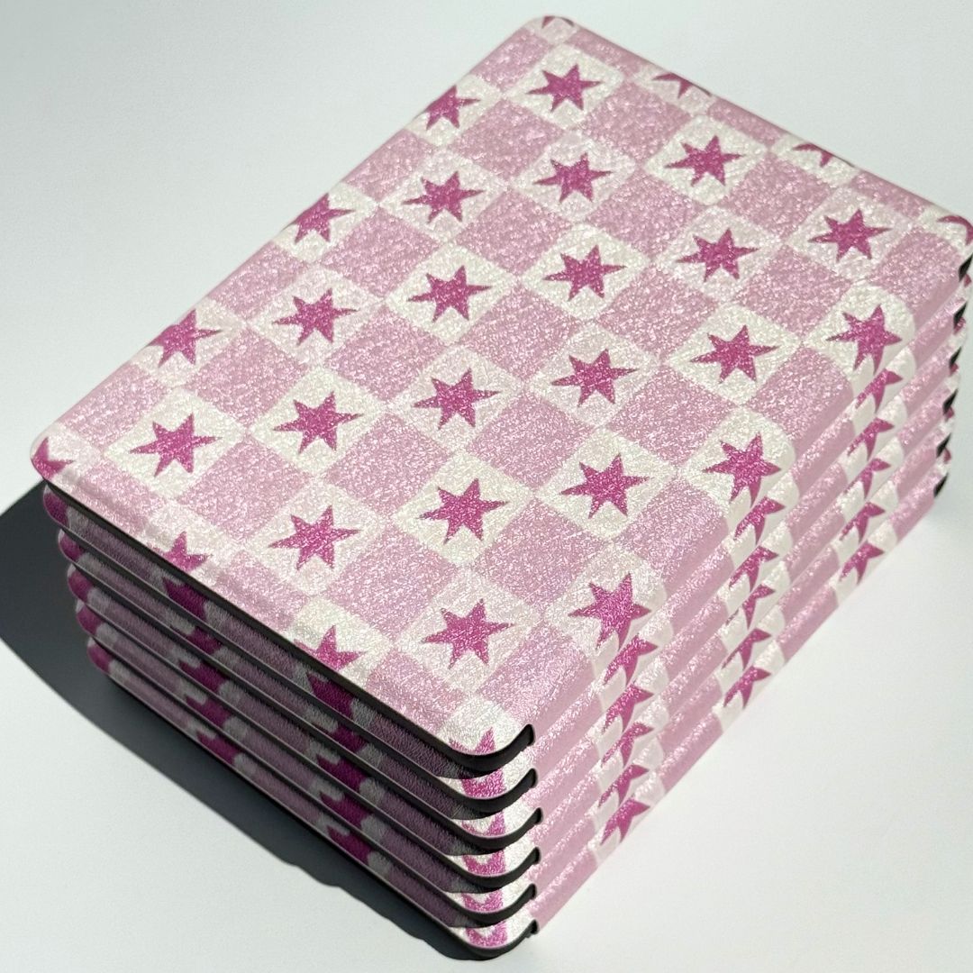 Side stack of Blush Cosmos pink star Kindle cases highlighting reinforced protective corners