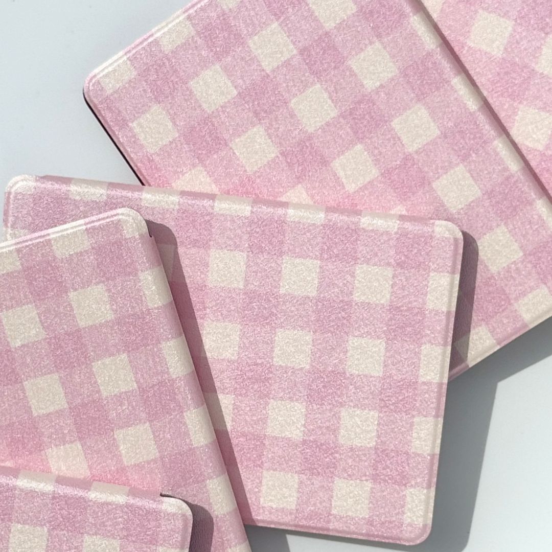 Side view of stacked pink gingham Blush Lover Kindle cases highlighting reinforced protective corners