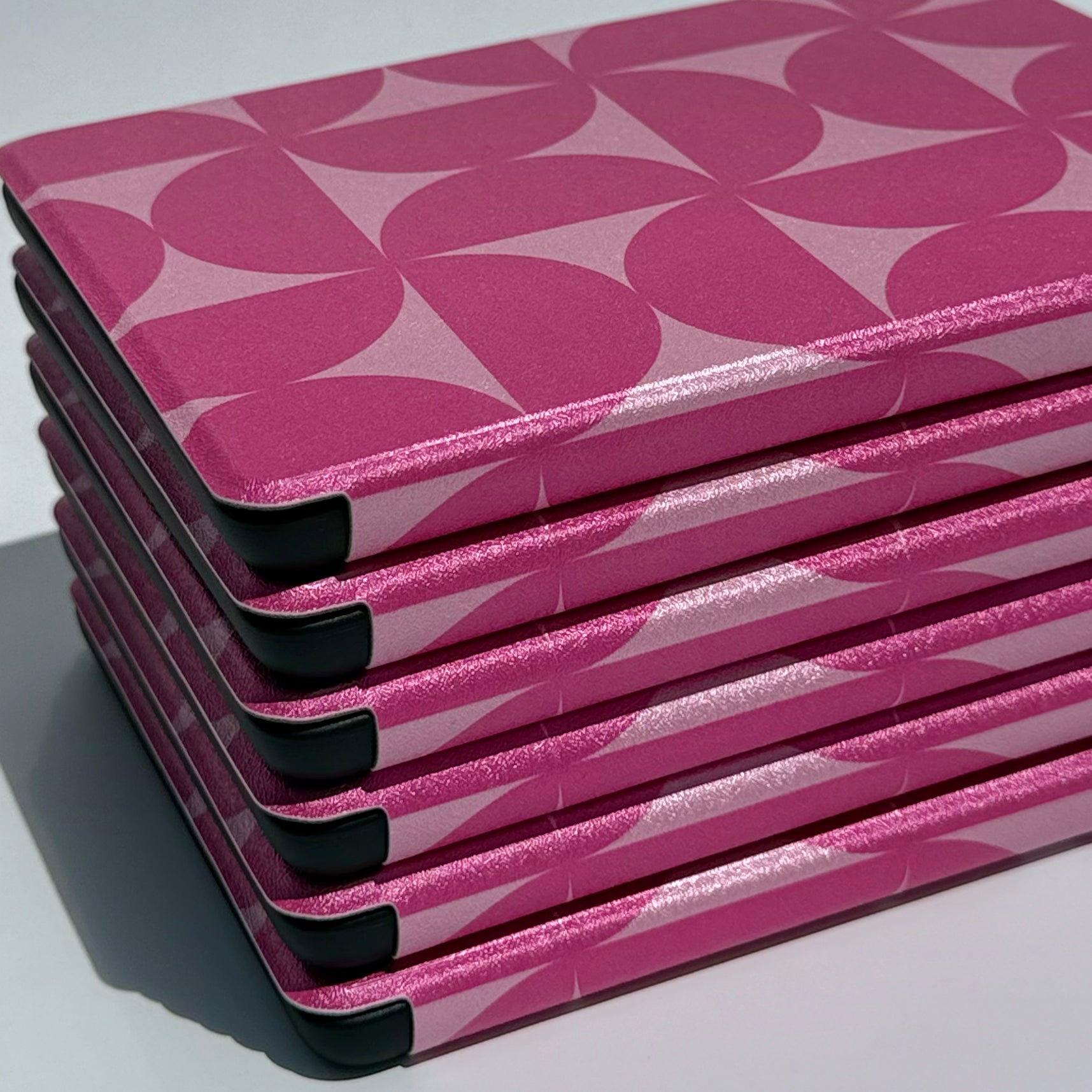Blushing Moon Kindle Case - spine view of stack of pink cases