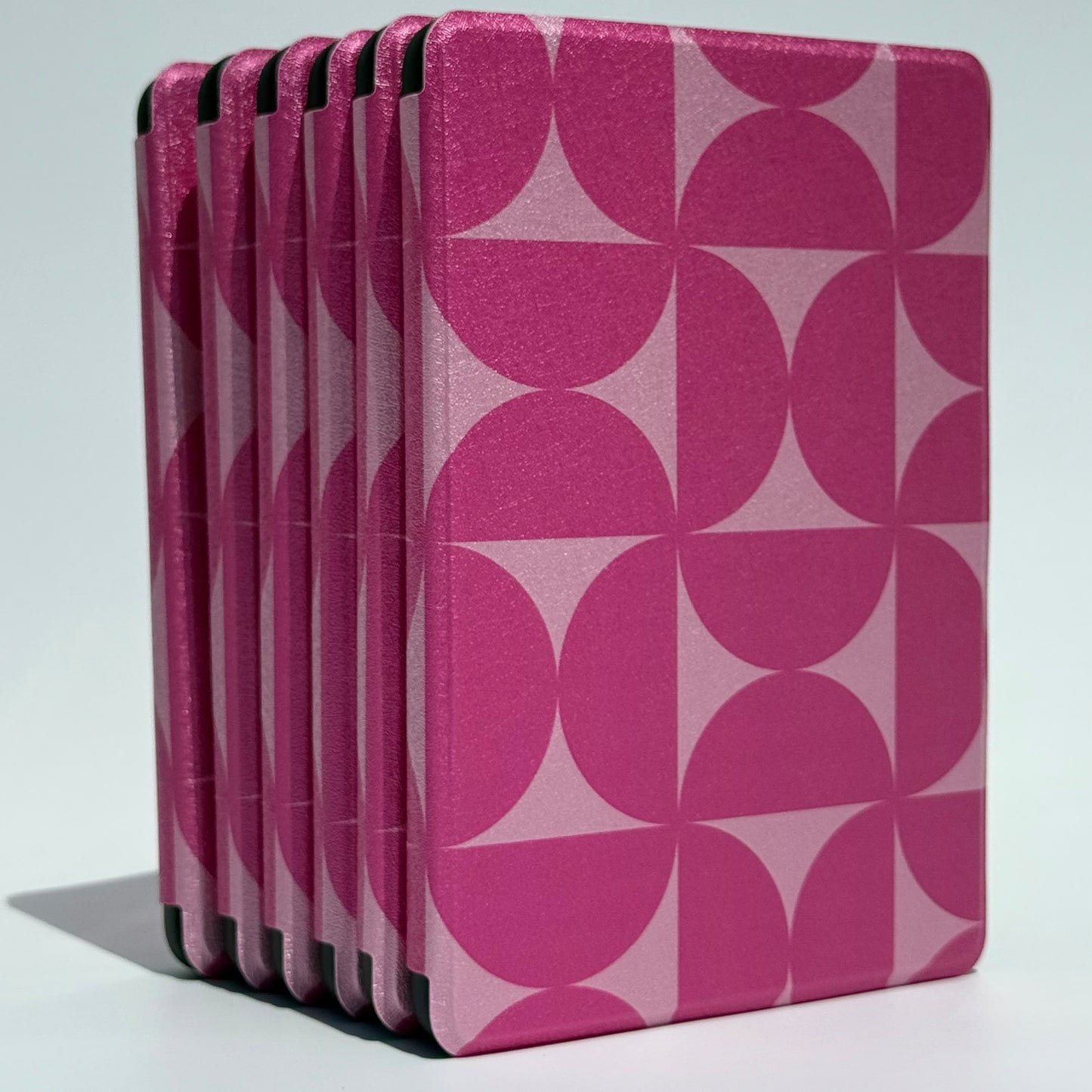 Blushing Moon berry pink geometric Kindle case, standing with hand strap