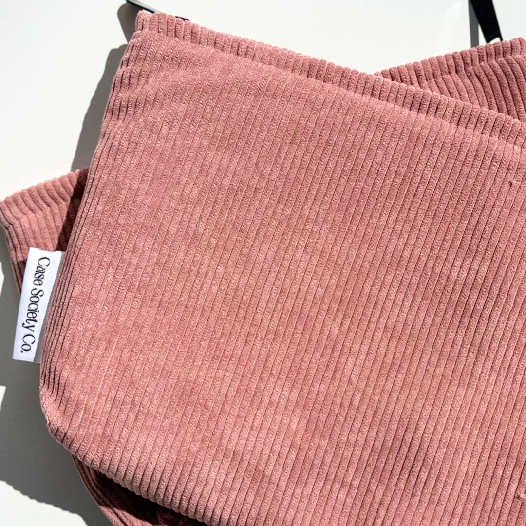 Back of the blush corduroy pouch showing the woven Case Society Co label