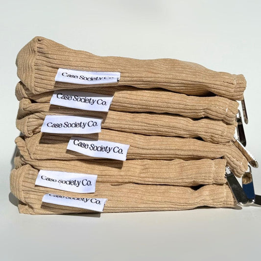 Stack of Book Club e-reader pouches in mocha, powder blue, honey and blush corduroy