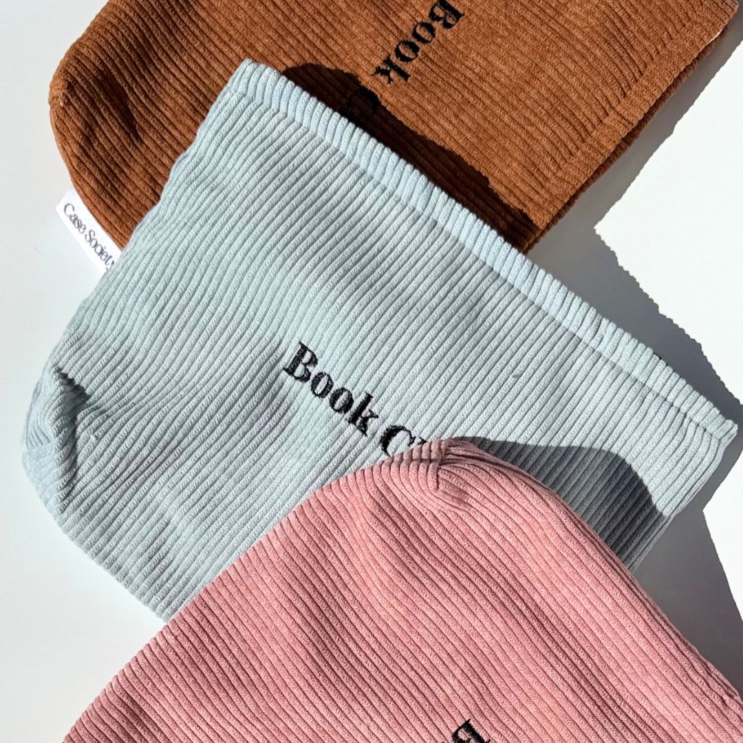 Book Club pouches in mocha, powder blue and blush pink corduroy fanned together