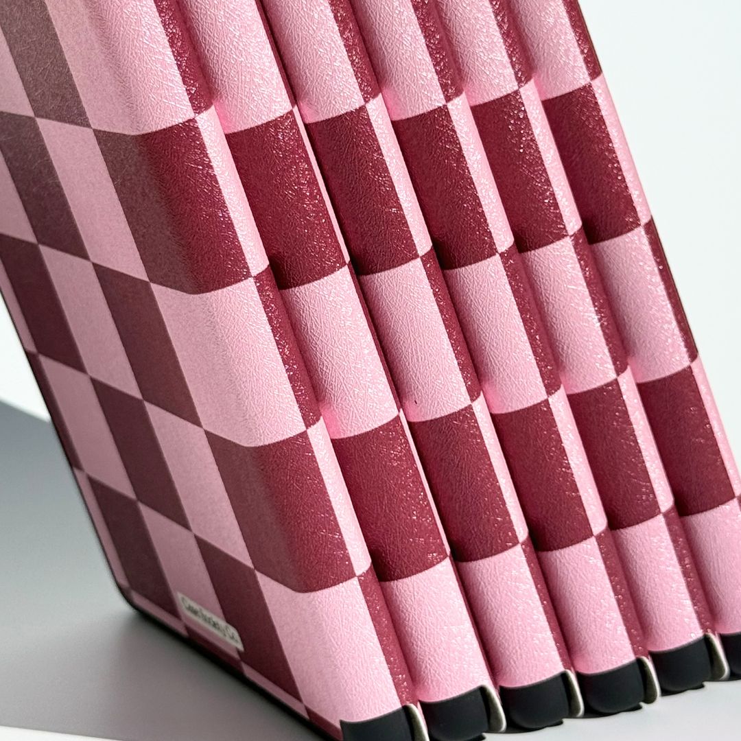 Bordeaux Fiction Kindle cases standing upright showing spine edges and slim checkered profile