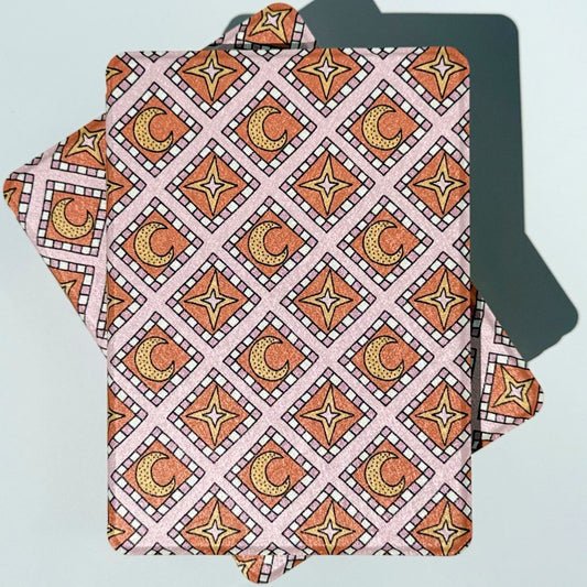 
Pink Celestia Kindle case with moon and star pattern, shown front and back in a flat lay