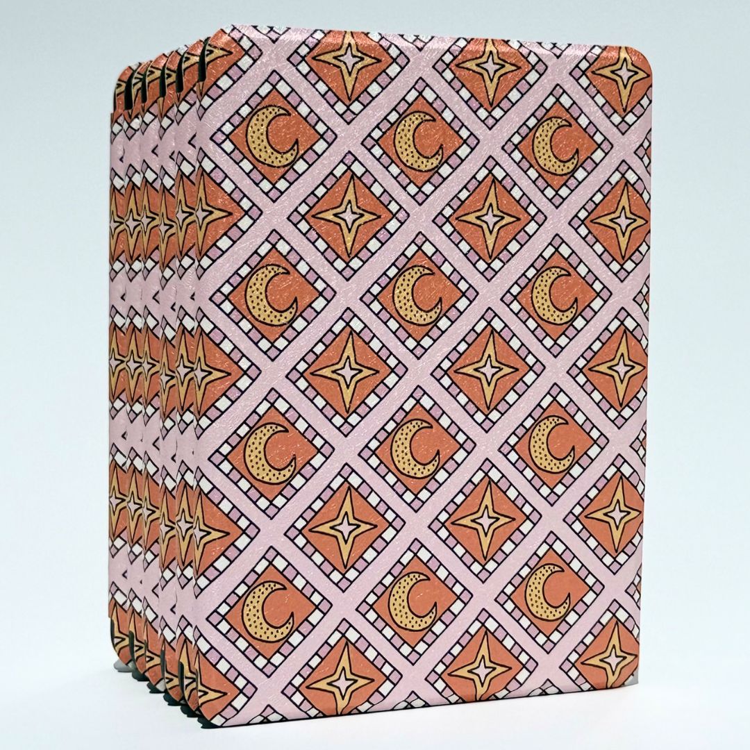 Close-up of the Celestia Kindle case spine and dual magnet closure in pink celestial print