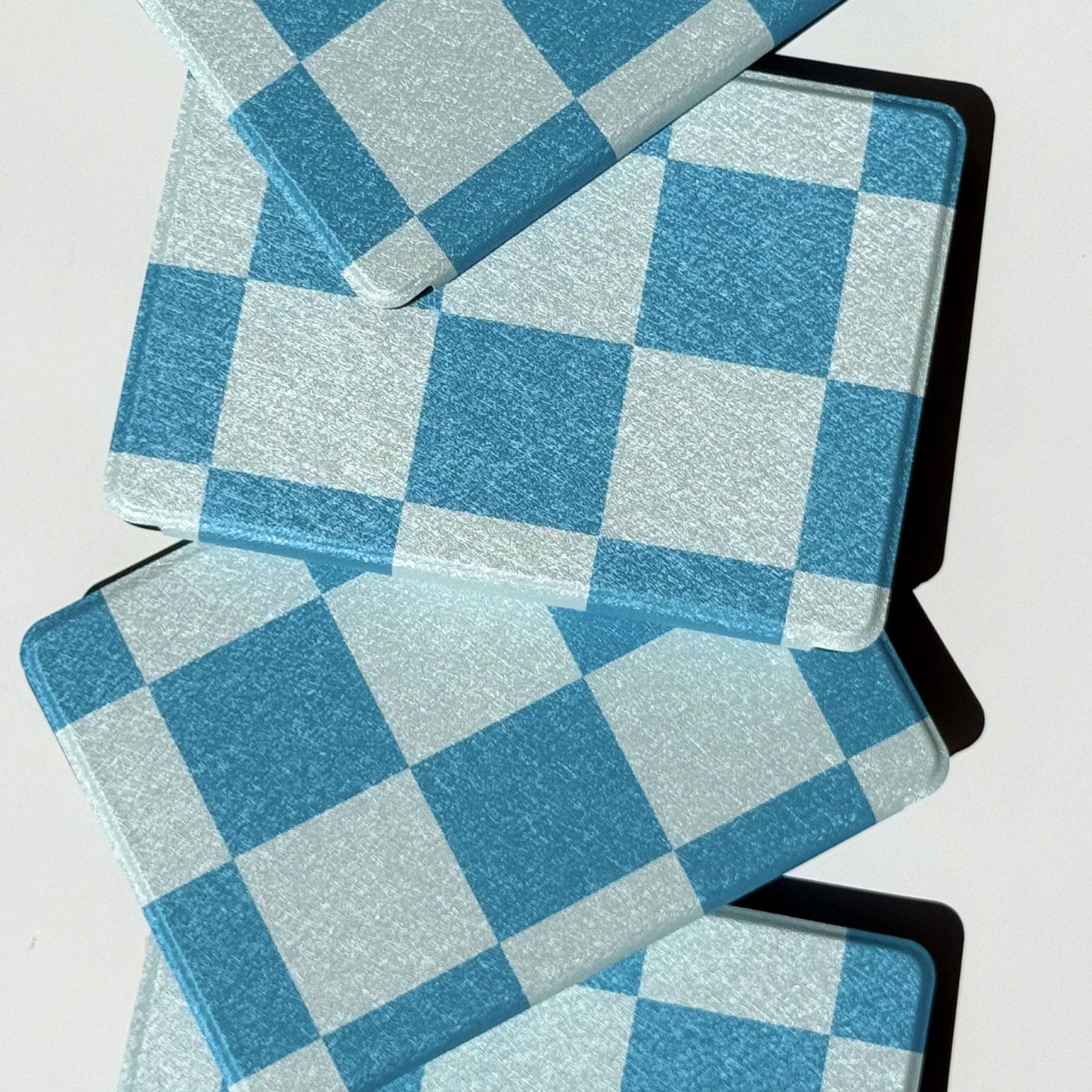 Blue gingham Kindle cases stacked, showing the Case Society Co label