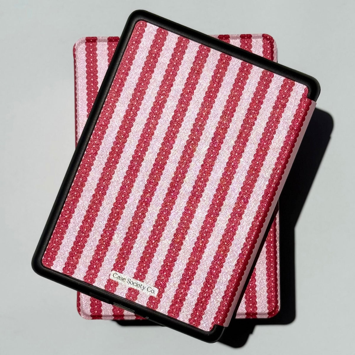 Back of the Cherry Ledger Kindle case on a Paperwhite, with the Case Society Co label