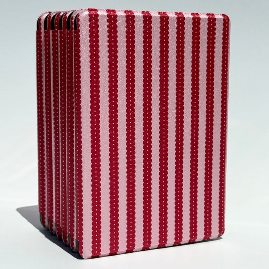 Cherry Ledger Kindle case standing upright, cherry red scalloped stripes on shimmer pink
