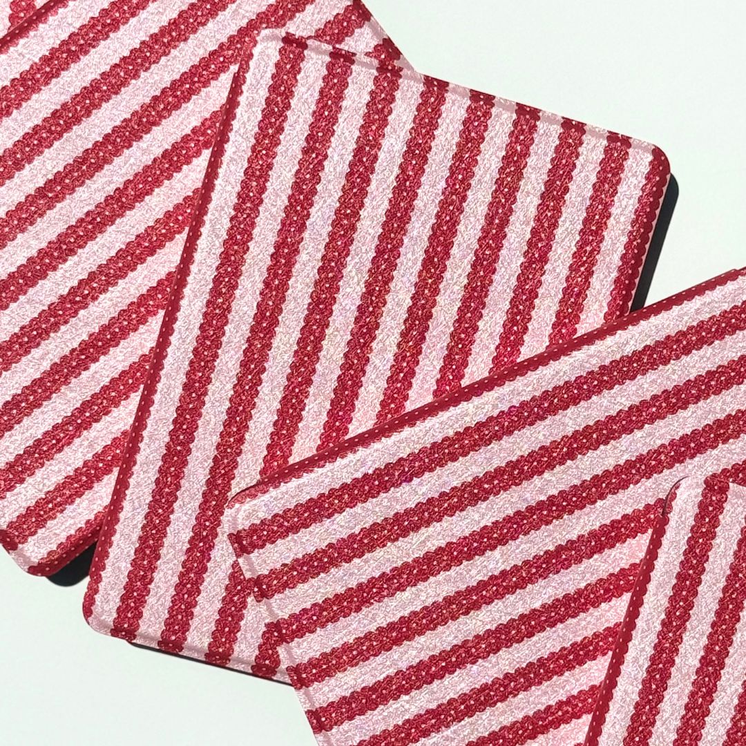 Cherry Ledger striped Kindle cases from Case Society Co crossed at an angle in the sun.