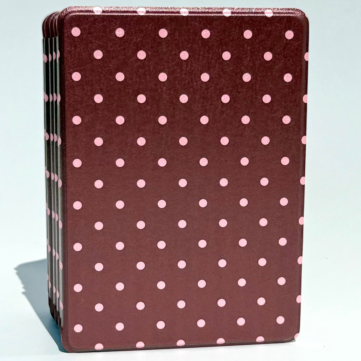 Cocoa Kiss Kindle cases stacked straight on, blush pink polka dots across a rose brown shell
