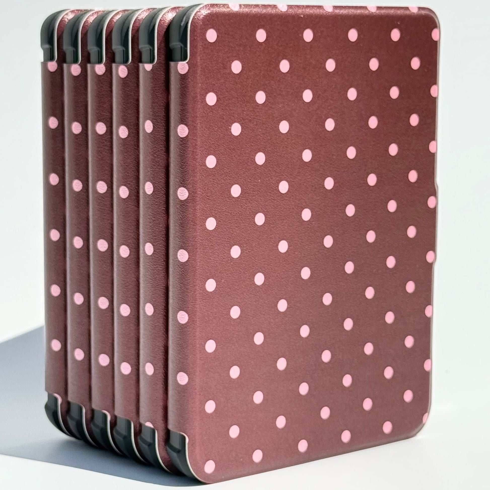 Cocoa Kiss Kobo Clara cases standing upright, brown covers with soft pink polka dots