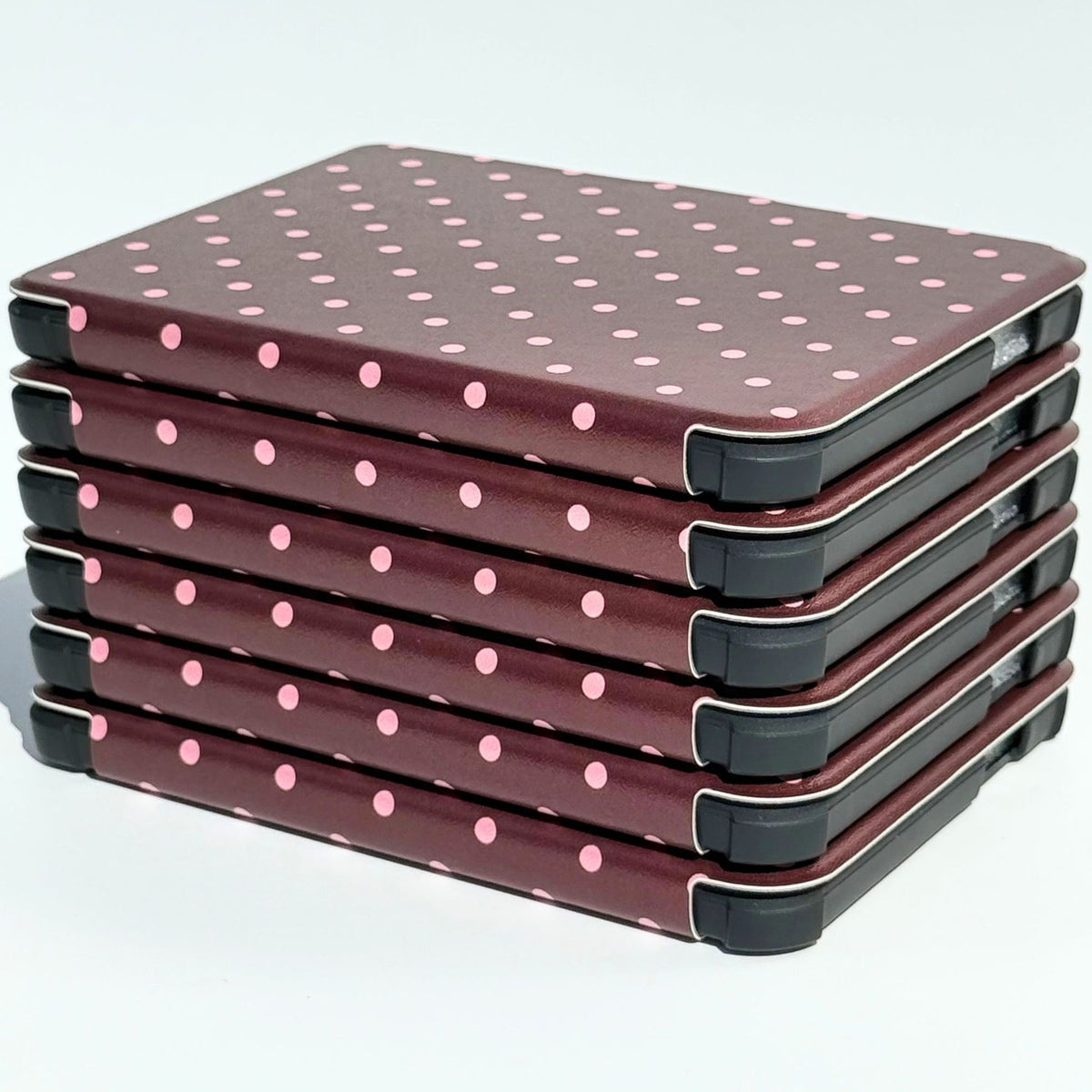 Stack of Cocoa Kiss Kobo Clara cases with protective corner bumpers, brown polka dot covers