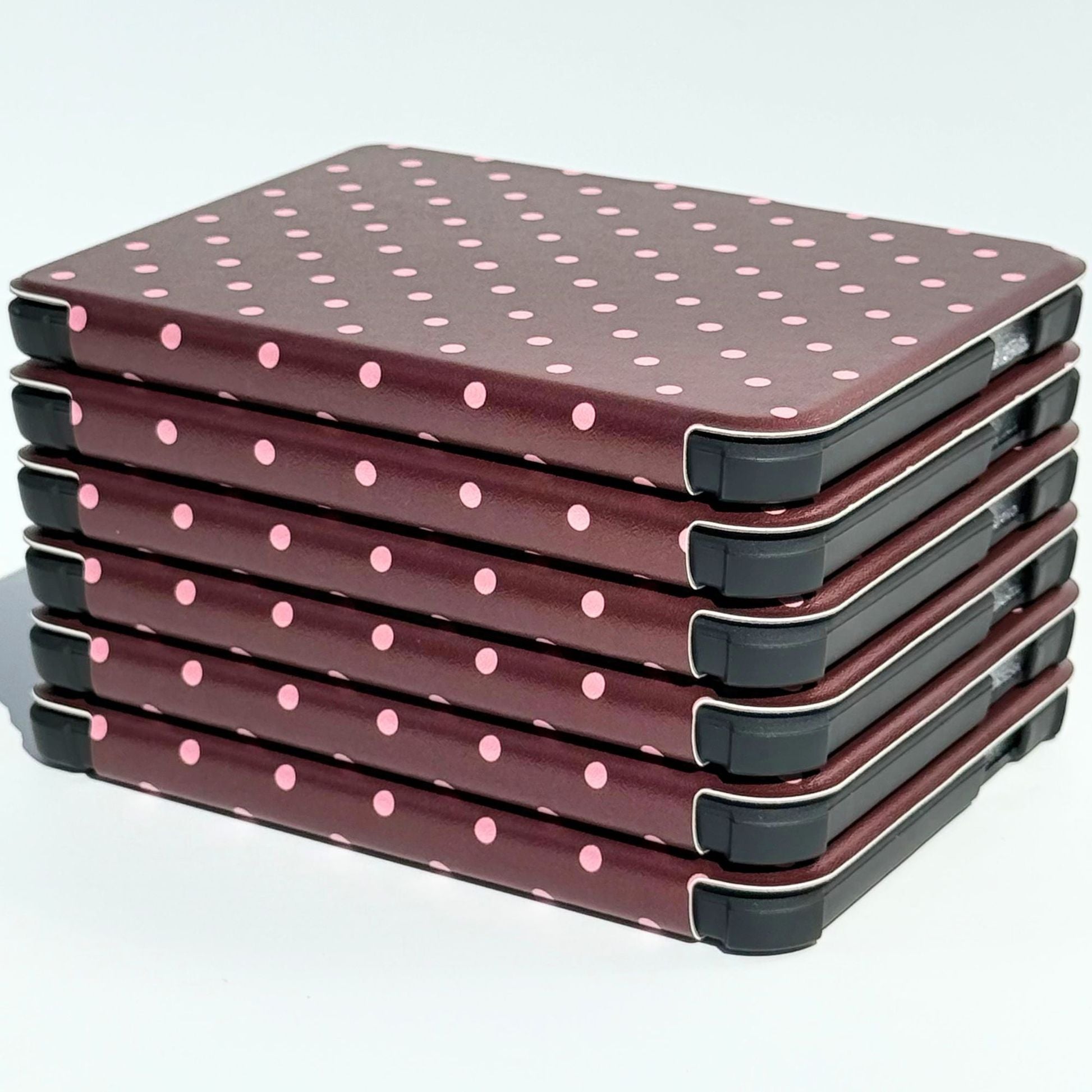 Stack of Cocoa Kiss Kobo Clara cases with protective corner bumpers, brown polka dot covers