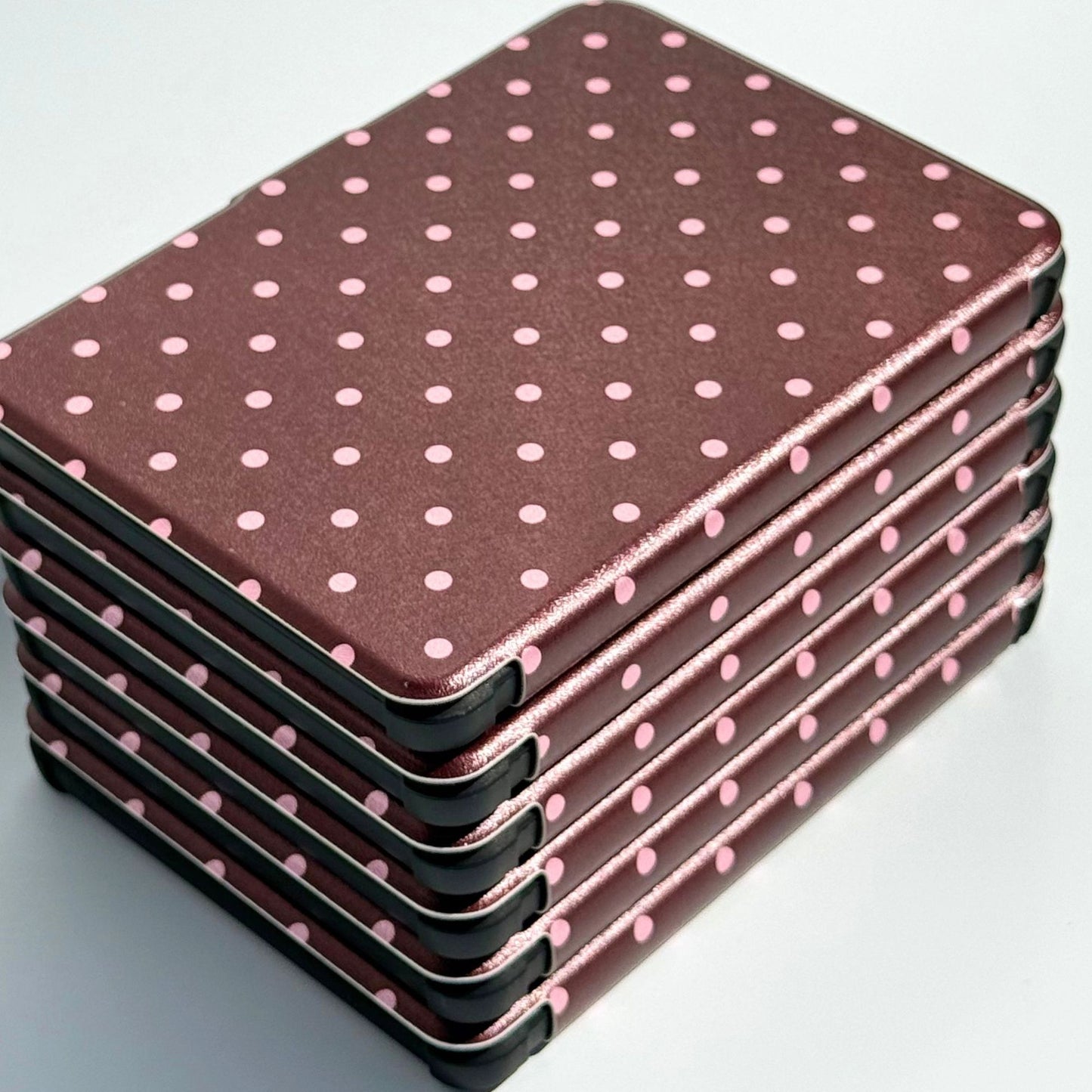 Angled stack of Cocoa Kiss Kobo Clara cases, pink polka dots on chocolate brown, Case Society Australia