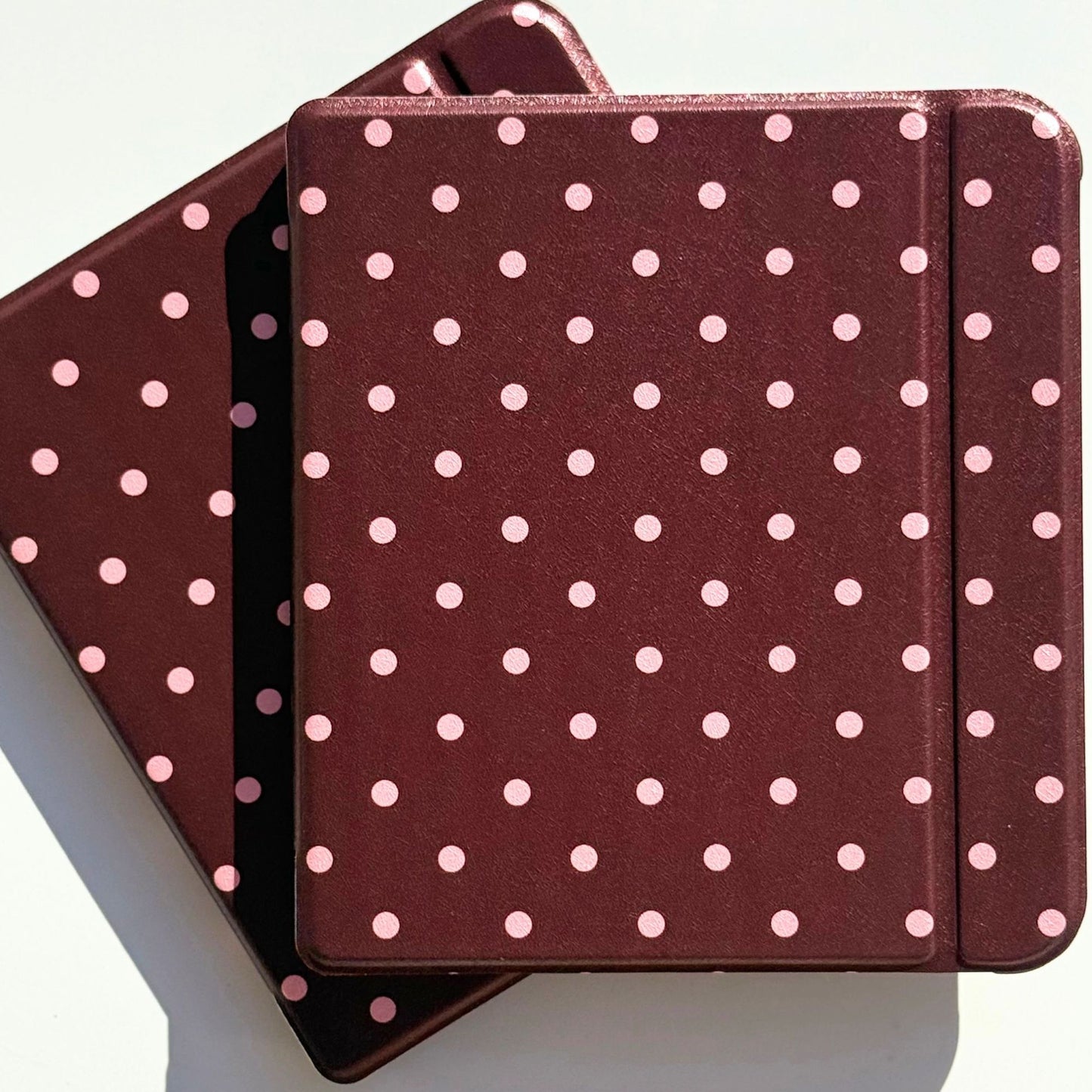 Cocoa Kiss Kobo Libra folio cover resting on a second case, brown with pink dots