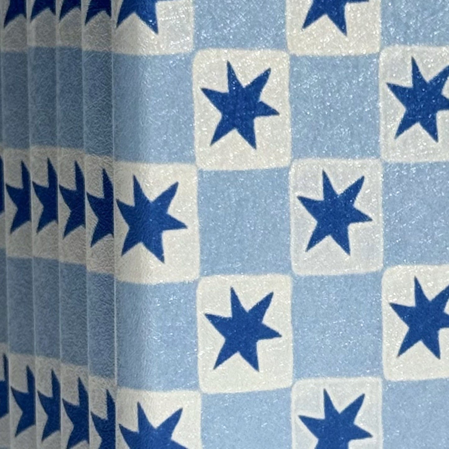 Close-up of the blue star check on a Falling Stars Kobo Clara case, Case Society Co