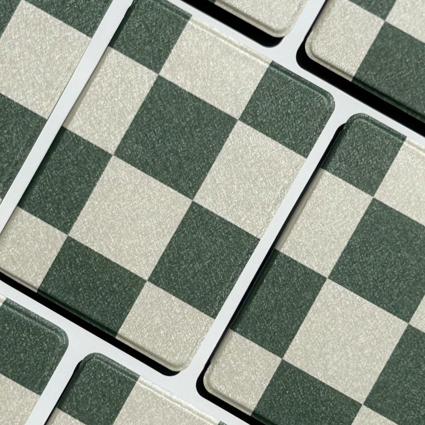Forest Lore green checkerboard Kindle cases laid in a diagonal flatlay — Case Society Australia