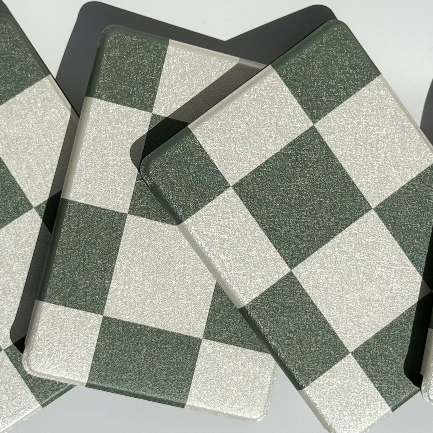 Two Forest Lore green checkered Kindle cases angled on edge — dark academia aesthetic bookish case