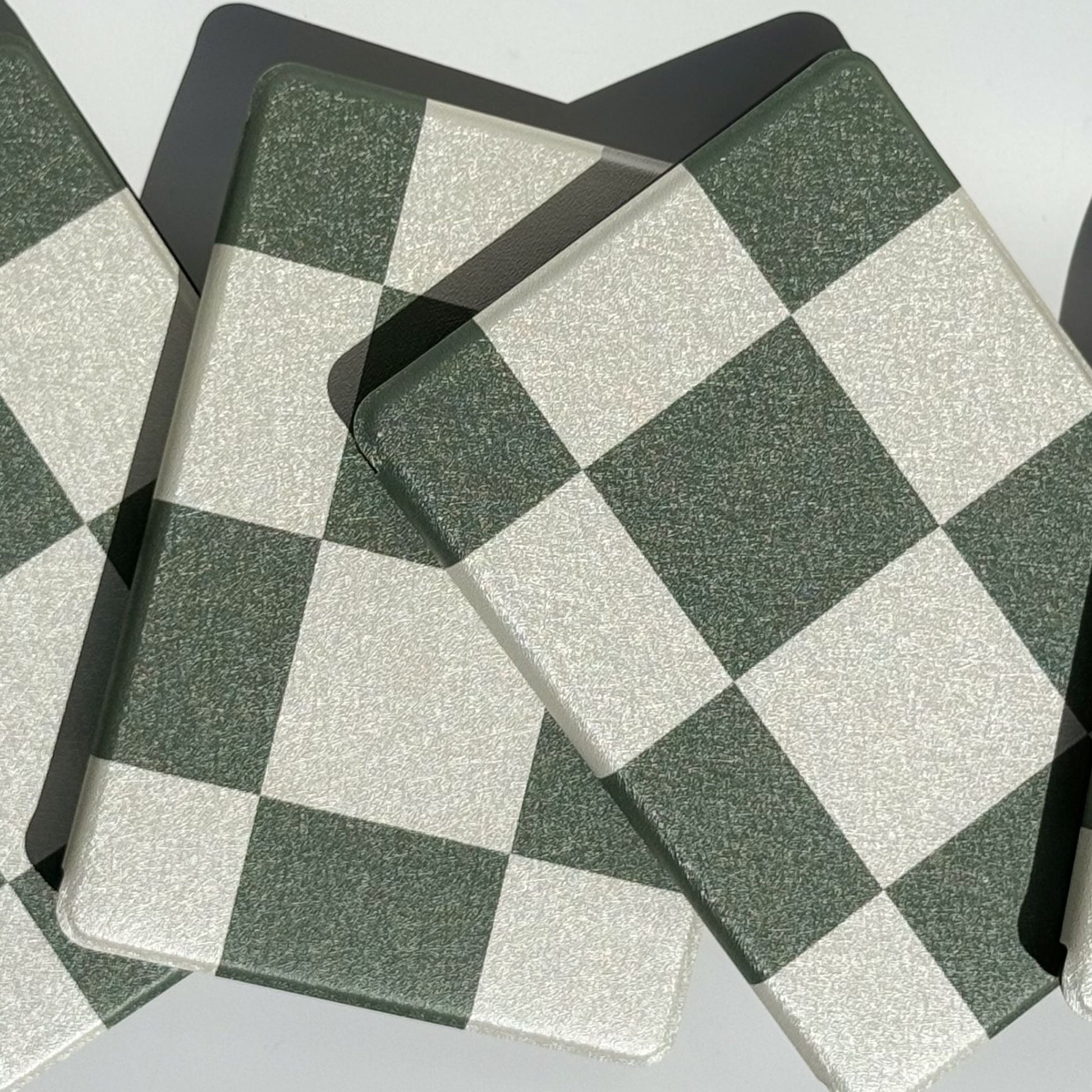 Two Forest Lore green checkered Kindle cases angled on edge — dark academia aesthetic bookish case