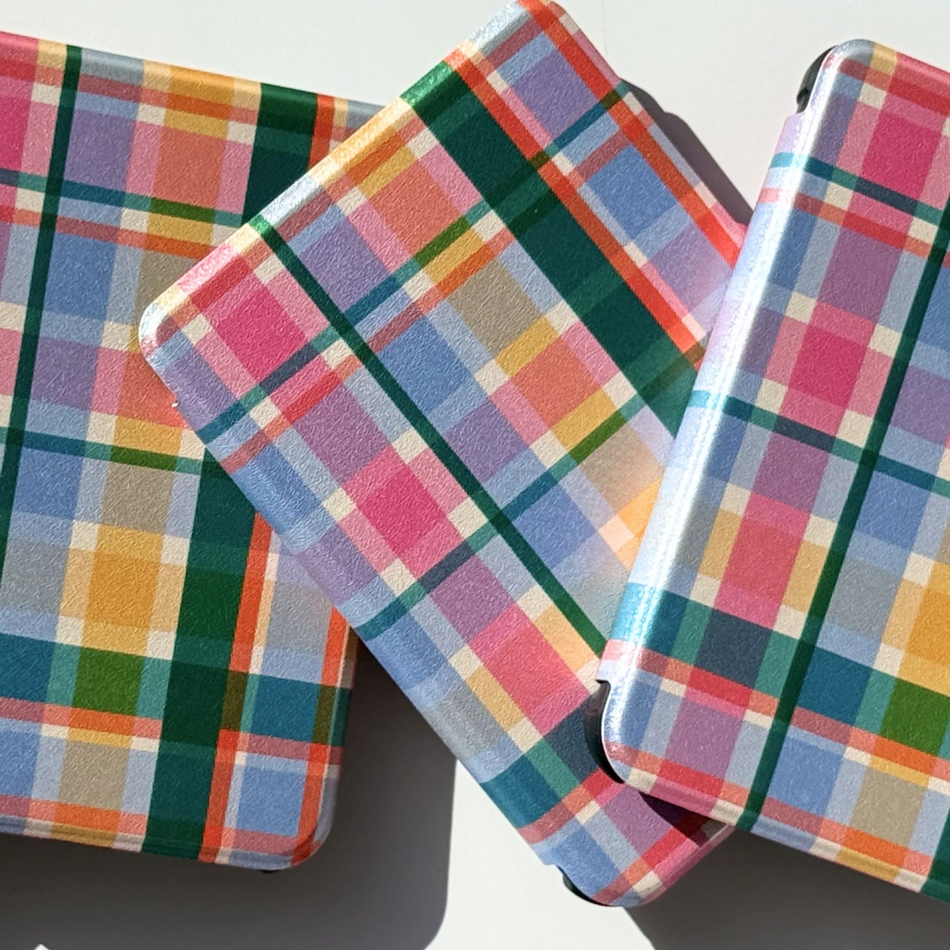 Colorful checkered Kobo case stacked upright.