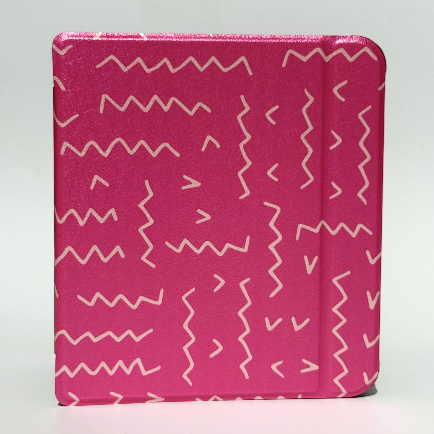 Flat lay of three Literary Lines Kobo Libra cases in hot pink — perfect bookworm gift Australia