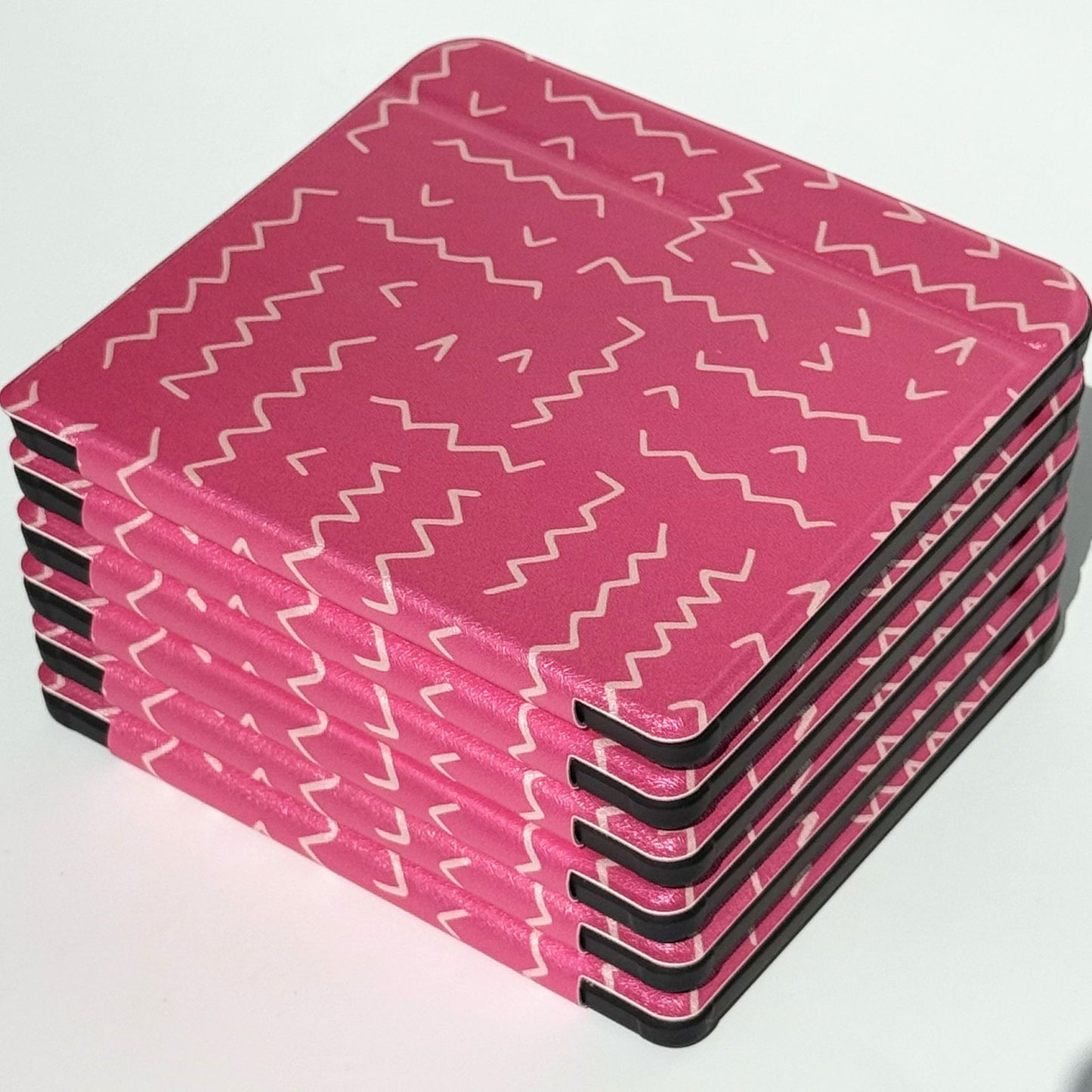 Perspective view of Literary Lines Kobo Libra cases stacked, cute pink zigzag print bookworm gift