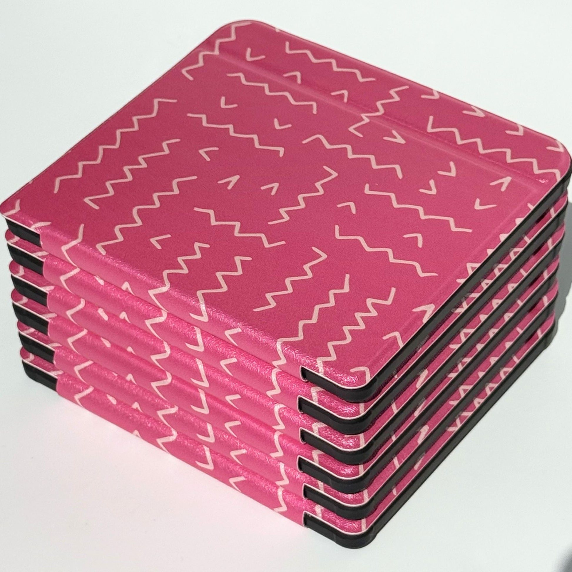 Perspective view of Literary Lines Kobo Libra cases stacked, cute pink zigzag print bookworm gift