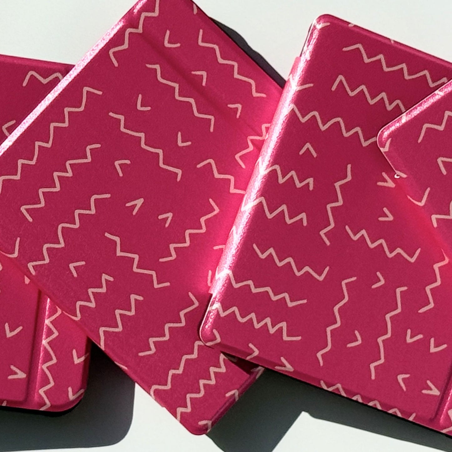 Stacked Literary Lines Kobo Libra cases from the side, pink line pattern with shockproof corners