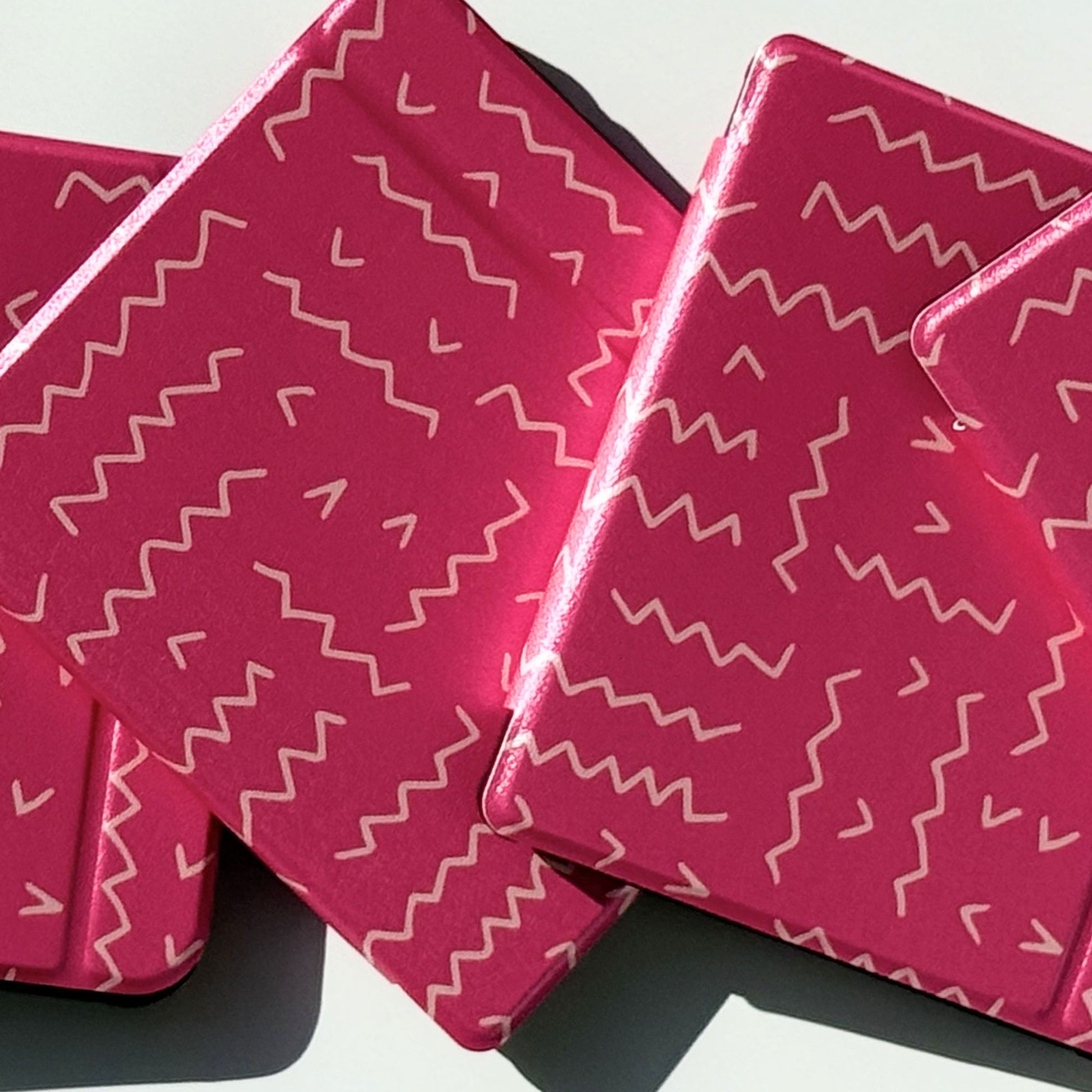 Stacked Literary Lines Kobo Libra cases from the side, pink line pattern with shockproof corners