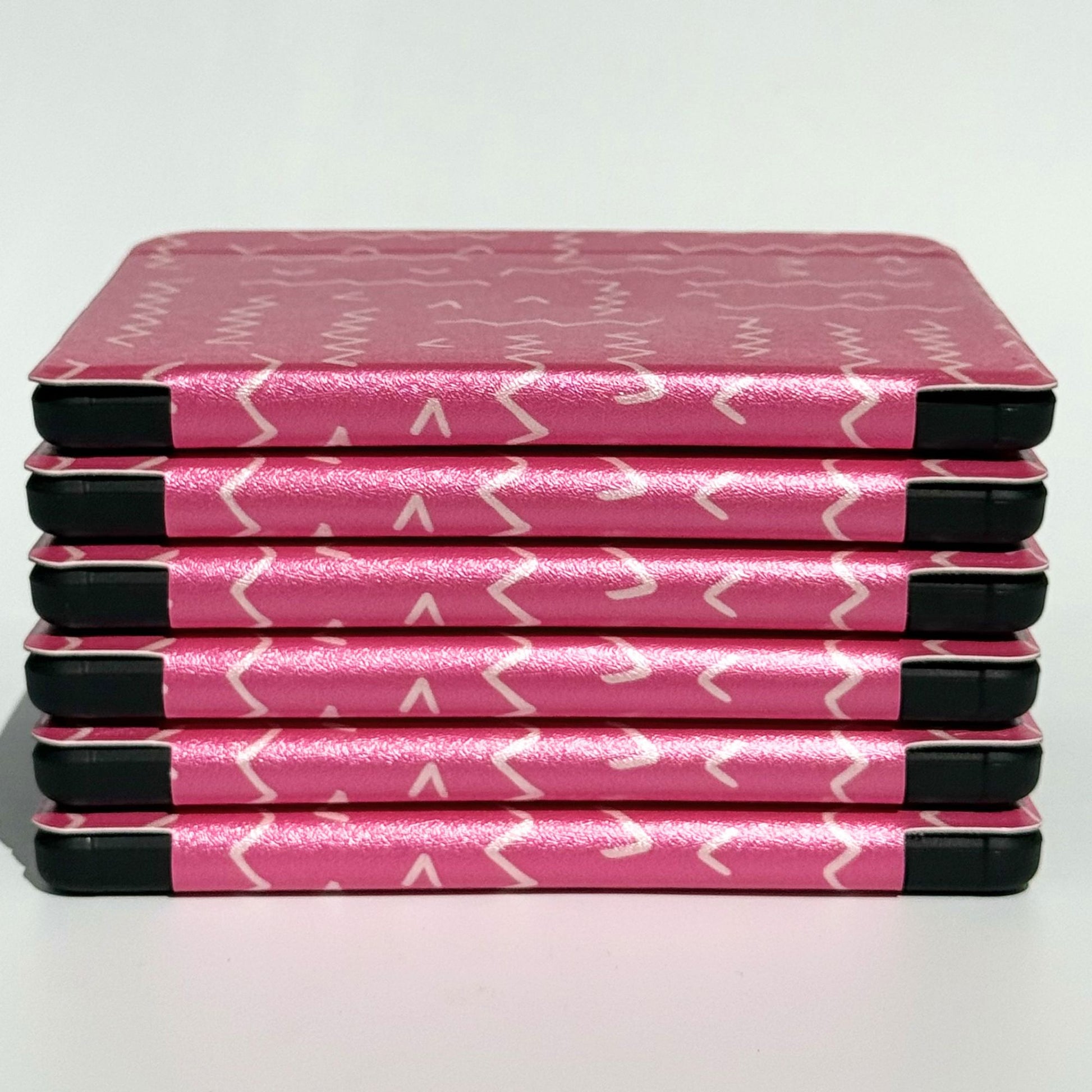 Side profile of Literary Lines Kobo Libra cases stacked, hot pink squiggle print with shockproof black bumper