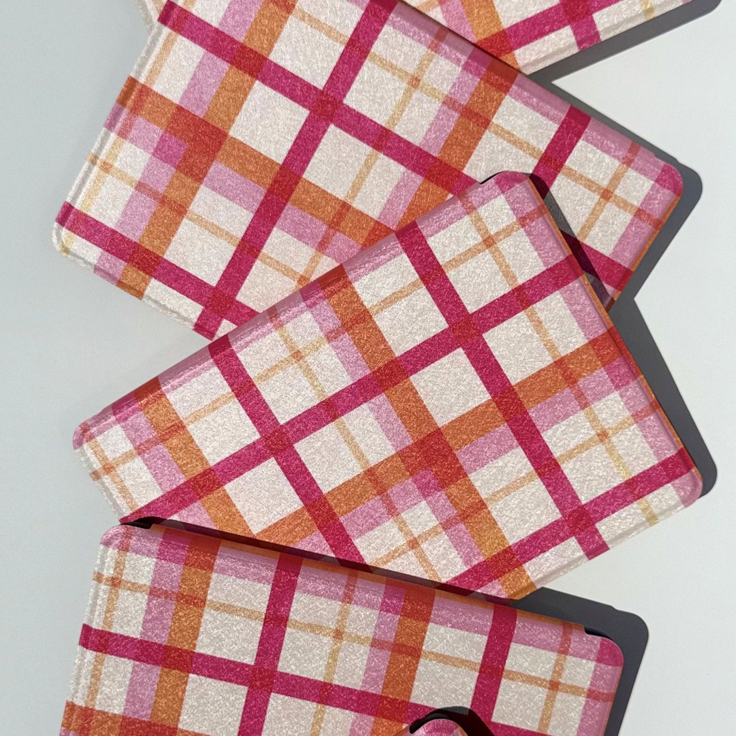 Aesthetic pink plaid Kindle cases on black Kindles, shipped from Australia