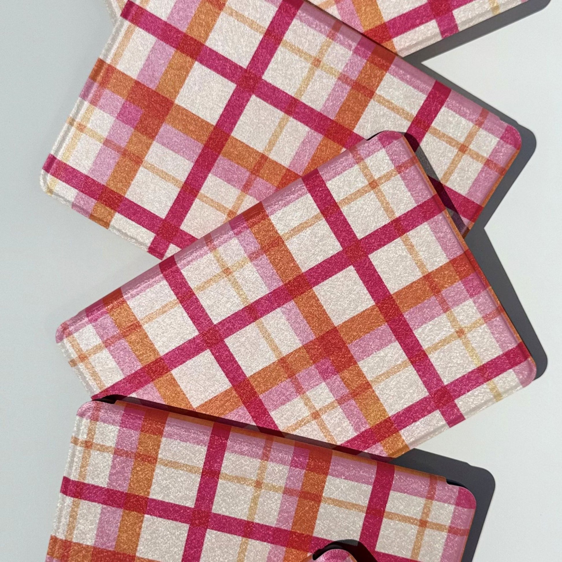 Aesthetic pink plaid Kindle cases on black Kindles, shipped from Australia
