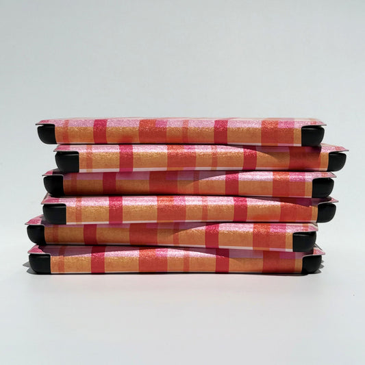 Preppy pink plaid Kindle cases in a top-down flatlay