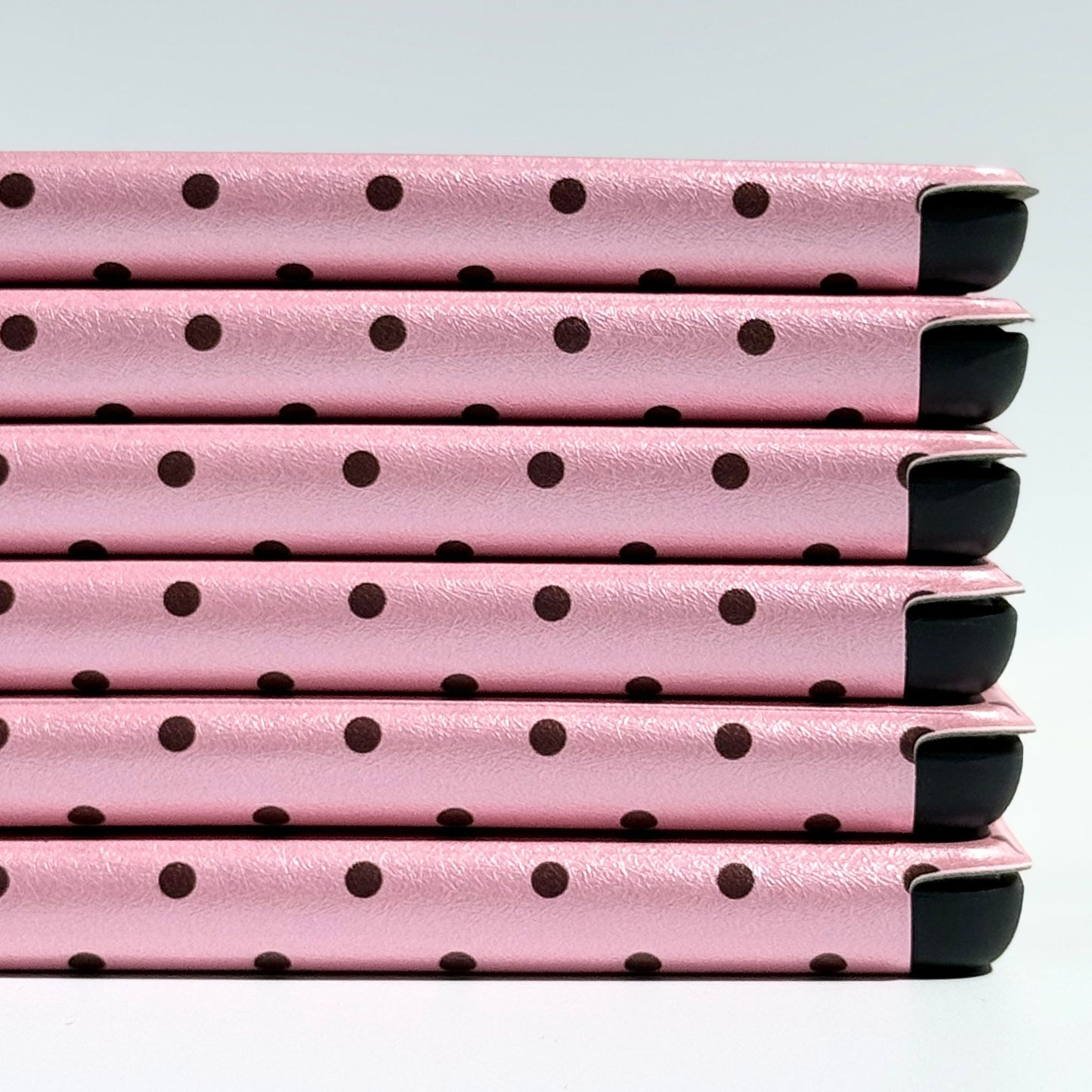 Pink Reverie Kindle case spine detail in blush pink with polka dots