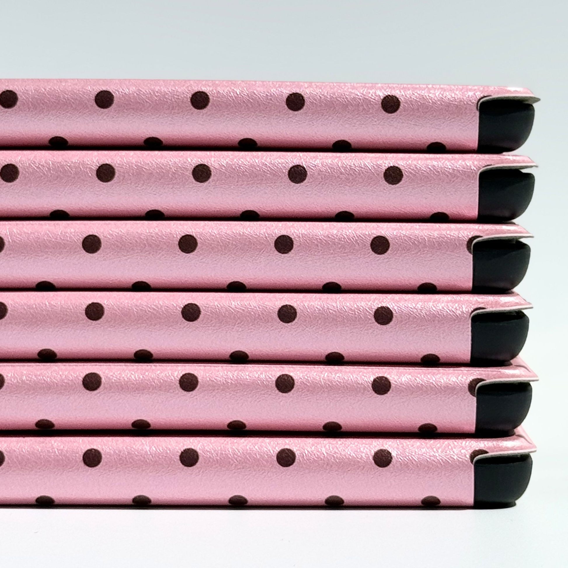 Pink Reverie Kindle case spine detail in blush pink with polka dots