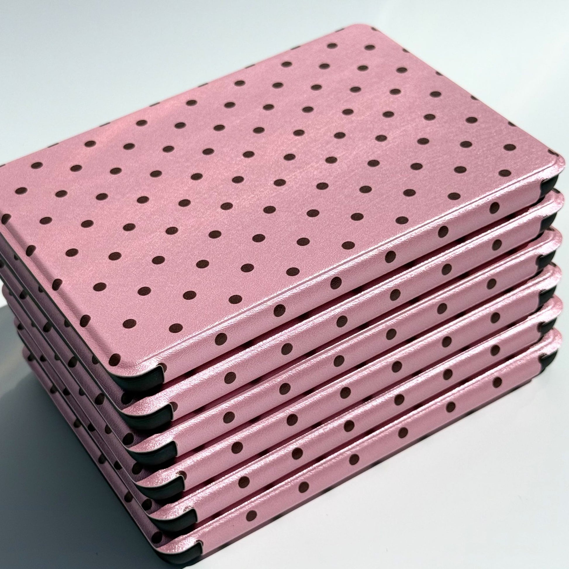 Pink Reverie pink polka dot Kindle cases stacked at an angle, top view by Case Society