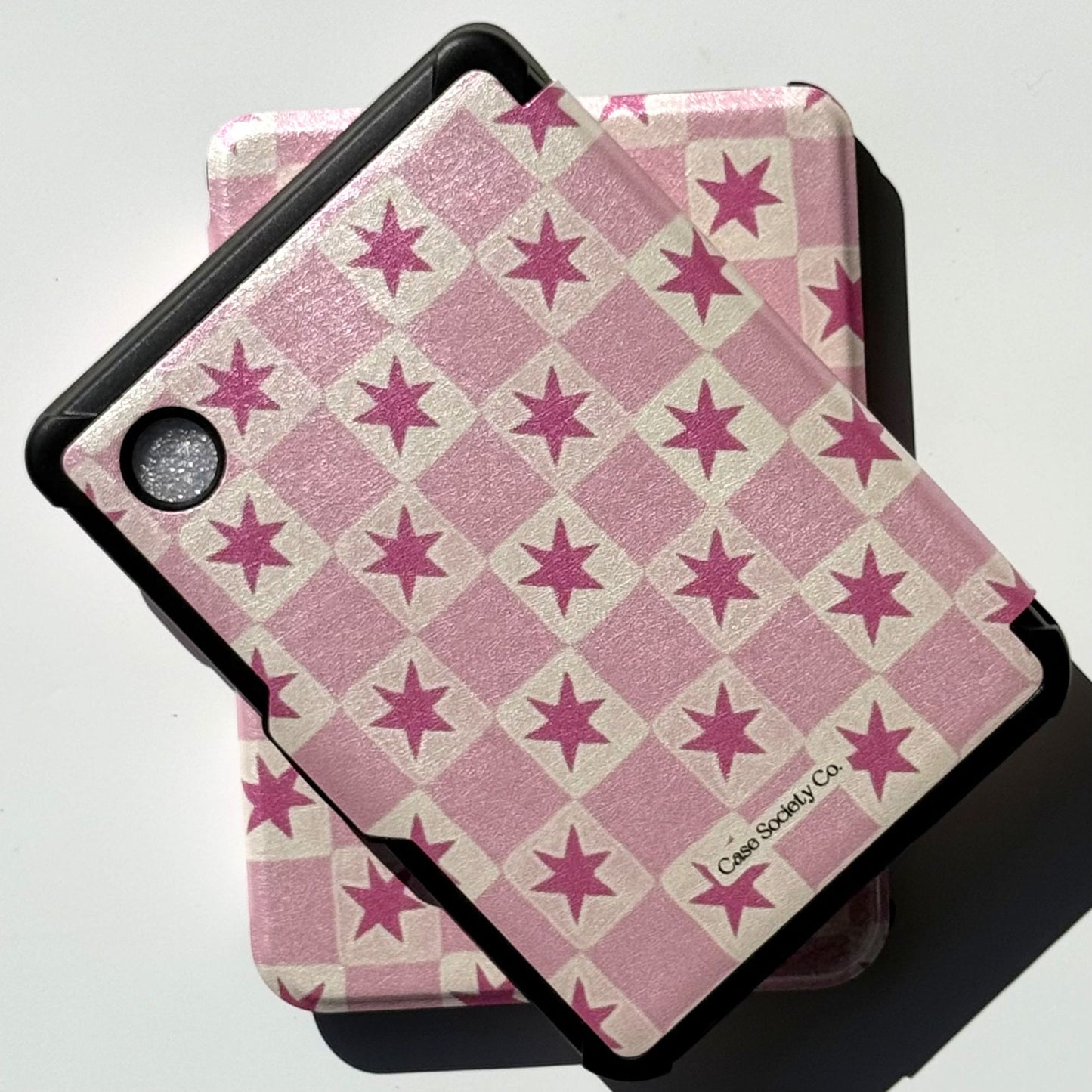 Pink star check Kobo Clara cases in a flatlay