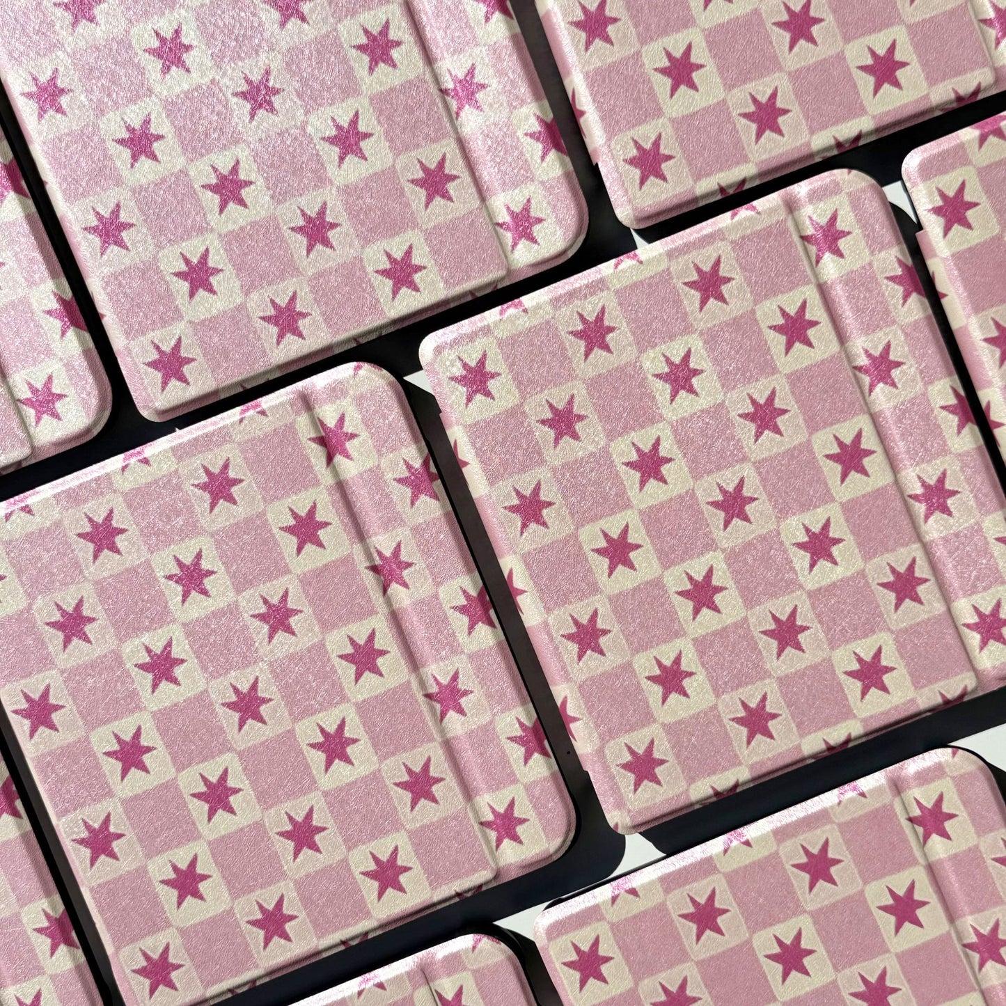 Pink star check Kobo Libra cases in a flatlay