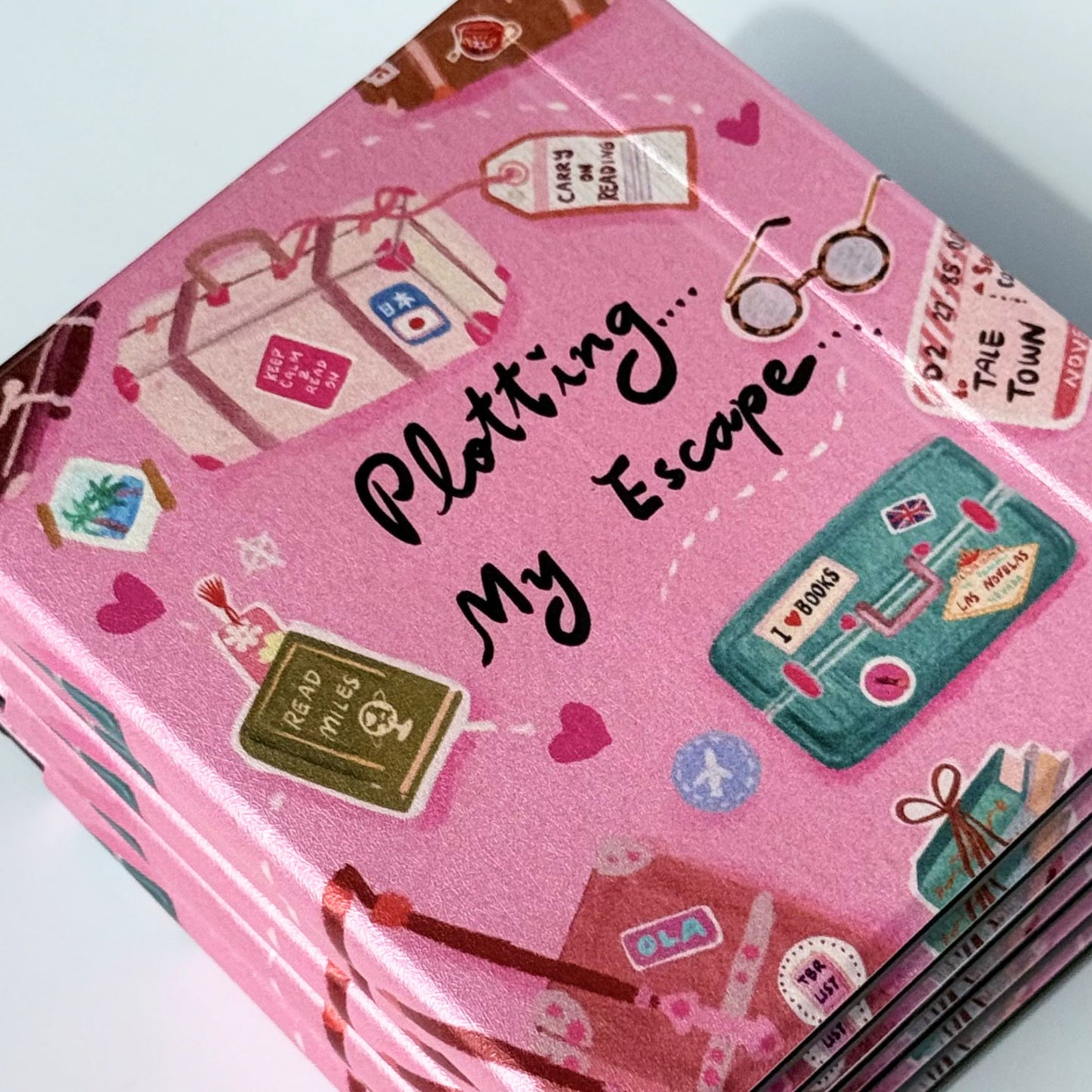 Stacked Plotting My Escape Kobo Libra cases showing back detail and pink aesthetic bookworm print