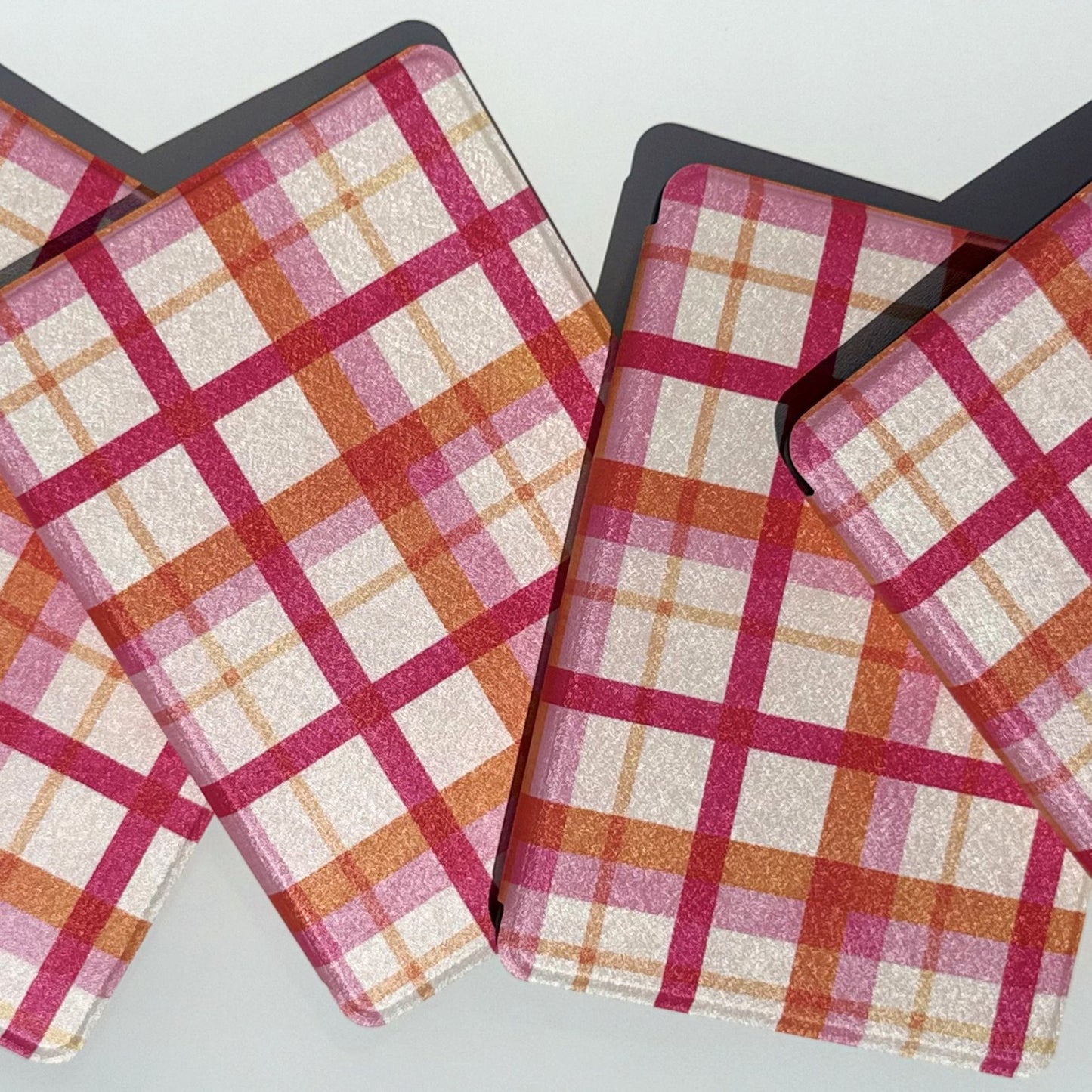 Roseline pink plaid Kindle cases in a neat stack