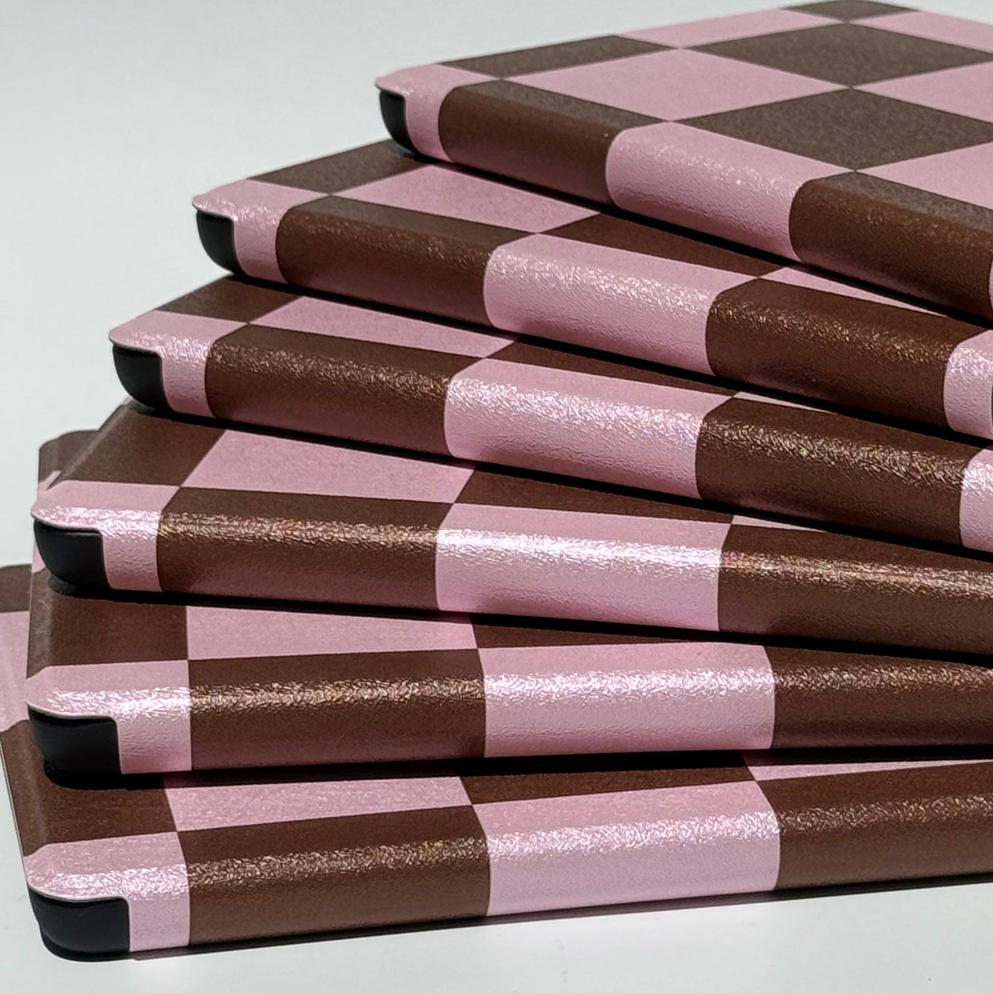 Back of She's Checked In Kindle case showing pink and brown checkerboard print and rounded corners