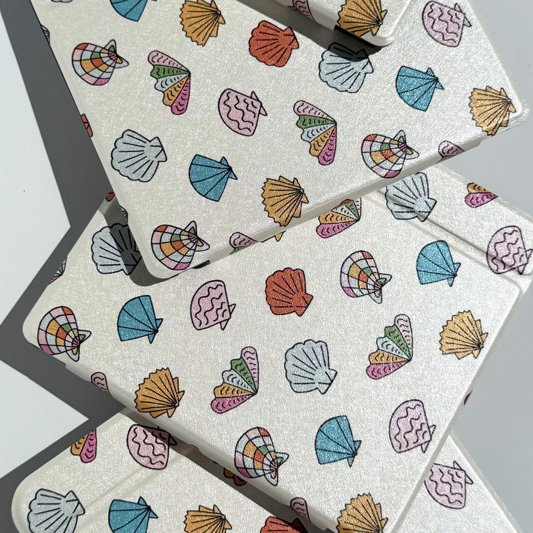shores of ophelia kobo libra cases laying flat with cute shell pattern