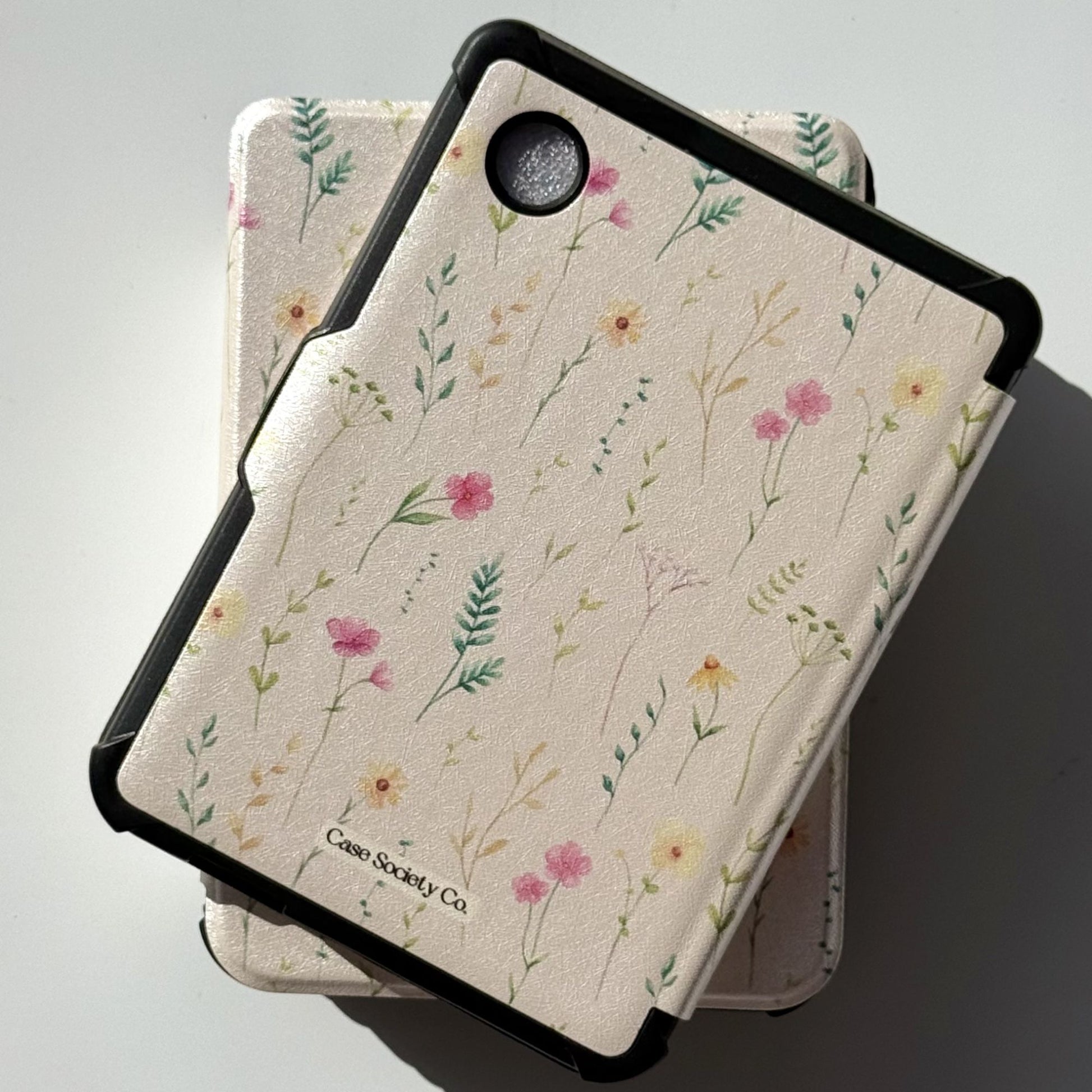 Back view of Spring Court Kobo Clara case in cream with pressed wildflower print — pink and yellow flowers, ferns and botanical sprigs ACOTAR-inspired