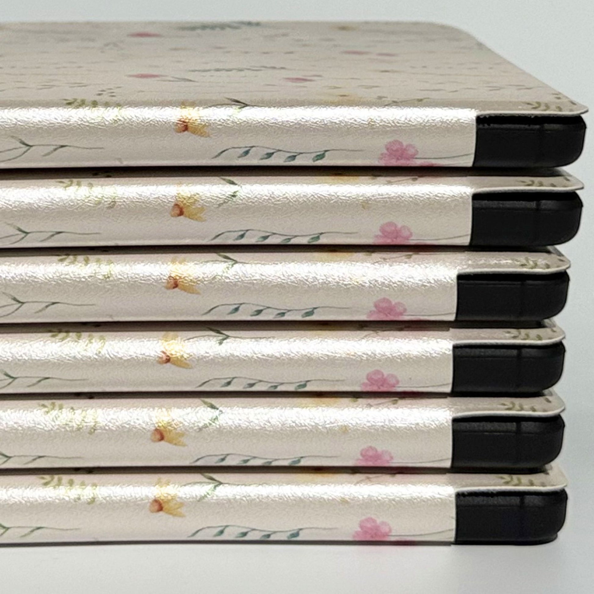 Back of Spring Court Kobo Libra case showing precise camera cutout, black shockproof bumper and Case Society Co. logo on cream pressed-flower print